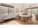 Open-concept dining space with a round table, seating for six, and adjacent living area with balcony access at 20100 N 78Th Pl # 2210, Scottsdale, AZ 85255