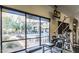Inside the fitness center, exercise equipment frames a view of the pool and patio at 20100 N 78Th Pl # 2210, Scottsdale, AZ 85255