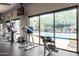 This fitness center features a range of equipment with a picturesque pool view, promoting wellness and relaxation at 20100 N 78Th Pl # 2210, Scottsdale, AZ 85255