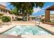 Inviting hot tub surrounded by lush greenery, lounge seating, and mature trees at 20100 N 78Th Pl # 2210, Scottsdale, AZ 85255
