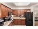 Kitchen area with stainless steel appliances, wood cabinets, granite countertops, and ample storage space at 20100 N 78Th Pl # 2210, Scottsdale, AZ 85255