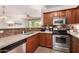 Well-lit kitchen boasts stainless steel appliances, stylish cabinetry, granite countertops, and modern backsplash at 20100 N 78Th Pl # 2210, Scottsdale, AZ 85255