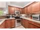Updated kitchen features stainless steel appliances, wood cabinets, granite countertops, and sleek backsplash at 20100 N 78Th Pl # 2210, Scottsdale, AZ 85255