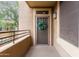 Private balcony featuring a secure entry door with decorative wreath, metal railing, and exterior lighting at 20100 N 78Th Pl # 2210, Scottsdale, AZ 85255