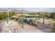 A playground area with slides and climbing structures with mountains visible in the background at 20100 N 78Th Pl # 2210, Scottsdale, AZ 85255