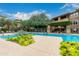 Relaxing community pool with lounge chairs, umbrellas, and lush landscaping for a serene atmosphere at 20100 N 78Th Pl # 2210, Scottsdale, AZ 85255