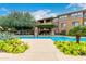 Inviting community pool surrounded by lush landscaping, lounge chairs, and shaded seating areas at 20100 N 78Th Pl # 2210, Scottsdale, AZ 85255