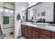 Stylish bathroom with double sinks, wood cabinetry, and modern fixtures, adjacent to a shower and bathtub at 20125 E Via Del Rancho --, Queen Creek, AZ 85142