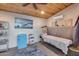 Cozy bedroom featuring wood ceilings, artwork, mini fridge, and professional work space at 20125 E Via Del Rancho --, Queen Creek, AZ 85142