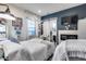 Bedroom featuring white bedding, shiplap, a sliding barn door, and a TV at 20125 E Via Del Rancho --, Queen Creek, AZ 85142