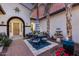 Charming courtyard with an outdoor dining set, decorative fountain, and lush floral accents at 20125 E Via Del Rancho --, Queen Creek, AZ 85142