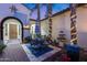 Charming courtyard featuring outdoor seating, lush plantings, and a decorative water fountain at 20125 E Via Del Rancho --, Queen Creek, AZ 85142