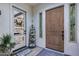 Charming covered front entry with a rustic door, decorative accents, and a peek into the bright kitchen at 20125 E Via Del Rancho --, Queen Creek, AZ 85142