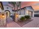 Inviting front entrance with a stone pillar, lush landscaping, and a brick-paved walkway to the home at 20125 E Via Del Rancho --, Queen Creek, AZ 85142