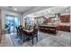 Open-concept kitchen and dining area with a large island, stone accents, and modern appliances at 20125 E Via Del Rancho --, Queen Creek, AZ 85142