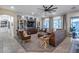 Spacious living room featuring built-in bookshelves, a large TV, and comfortable leather seating at 20125 E Via Del Rancho --, Queen Creek, AZ 85142