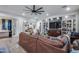 Cozy living room with leather furniture, a decorative bookshelf, and an open layout at 20125 E Via Del Rancho --, Queen Creek, AZ 85142