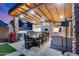 Stunning outdoor kitchen with pizza oven, stainless steel appliances, and large dining table at 20125 E Via Del Rancho --, Queen Creek, AZ 85142