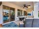 Inviting covered patio featuring comfortable seating, ceiling fan, and access to the backyard at 20125 E Via Del Rancho --, Queen Creek, AZ 85142