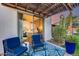 Comfortable patio with blue outdoor furniture and a glimpse of the primary bedroom at 20125 E Via Del Rancho --, Queen Creek, AZ 85142
