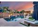 Inviting pool featuring a waterfall, fire bowls, and an outdoor kitchen, perfect for entertaining guests at 20125 E Via Del Rancho --, Queen Creek, AZ 85142