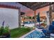 Beautiful outdoor pool area with waterfall feature, lounge chairs, and covered patio with dining space at 20125 E Via Del Rancho --, Queen Creek, AZ 85142