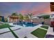 Beautiful backyard pool with lush landscaping, water features, and outdoor lounge area at 20125 E Via Del Rancho --, Queen Creek, AZ 85142