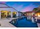 Beautiful pool with rock waterfall feature, surrounded by lush landscaping and outdoor seating at 20125 E Via Del Rancho --, Queen Creek, AZ 85142