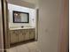 Well-lit bathroom features a neutral vanity with a framed mirror and tile flooring at 2035 S Elm St # 114, Tempe, AZ 85282