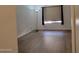 Bedroom featuring laminate flooring and a large window with blinds at 2035 S Elm St # 114, Tempe, AZ 85282