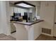 Updated kitchen featuring stainless steel appliances and breakfast bar open to the dining and living areas at 2035 S Elm St # 114, Tempe, AZ 85282