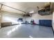 Spacious garage featuring epoxy floor and overhead storage racks, offering ample space at 22695 S 220Th St, Queen Creek, AZ 85142