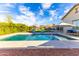 Inviting pool area featuring a sparkling pool, lounge chairs, and an umbrella for relaxing days at 22695 S 220Th St, Queen Creek, AZ 85142