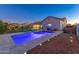 Sparkling swimming pool with lounge chairs surrounded by a beautifully landscaped backyard and privacy fence at 22695 S 220Th St, Queen Creek, AZ 85142