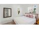 Cozy bedroom featuring a wood-framed bed, soft linens, and an elegant mirror at 2320 E Harvard St, Phoenix, AZ 85006
