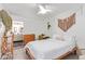 Light and airy bedroom featuring a ceiling fan, dresser, and desk with attached bath at 2320 E Harvard St, Phoenix, AZ 85006