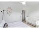 Bright bedroom featuring white walls, a flower wall design, and a cozy crib at 2320 E Harvard St, Phoenix, AZ 85006