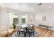 A dining area with neutral colors, contemporary furniture, wooden flooring, and bright natural light at 2320 E Harvard St, Phoenix, AZ 85006