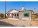 Single Gathering home with a white exterior, pink door, manicured yard, and a long driveway at 2320 E Harvard St, Phoenix, AZ 85006