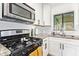Well-lit kitchen featuring granite countertops, subway tile backsplash, and stainless appliances at 2320 E Harvard St, Phoenix, AZ 85006