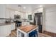 A renovated kitchen with stainless steel appliances, granite countertops, white cabinets, and a kitchen island at 2320 E Harvard St, Phoenix, AZ 85006
