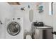 The laundry room has modern, stainless steel appliances and white walls at 2320 E Harvard St, Phoenix, AZ 85006