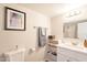 Clean, bright bathroom with neutral paint, white vanity and shelving unit at 2359 W Del Oro Cir, Mesa, AZ 85202