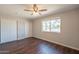 Clean bedroom with neutral tones, hardwood floors, ample closet space, and a bright window at 2359 W Del Oro Cir, Mesa, AZ 85202