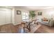 Inviting dining area featuring wood floors, dining table, modern decor, and natural light at 2359 W Del Oro Cir, Mesa, AZ 85202