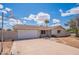 Charming one-story home with a basketball hoop and a well-manicured lawn under a bright sky at 2359 W Del Oro Cir, Mesa, AZ 85202