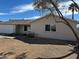 Single-story house with neutral exterior, low-maintenance desert landscaping, and a 2-car garage at 2359 W Del Oro Cir, Mesa, AZ 85202