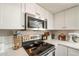 Well-equipped kitchen with stainless steel appliances, white cabinetry, and sleek countertops at 2359 W Del Oro Cir, Mesa, AZ 85202