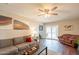 Bright living room with a ceiling fan, modern décor, hardwood floors, and access to the backyard patio at 2359 W Del Oro Cir, Mesa, AZ 85202