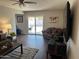 Bright living room with backyard access, comfortable seating and a modern entertainment setup at 2359 W Del Oro Cir, Mesa, AZ 85202